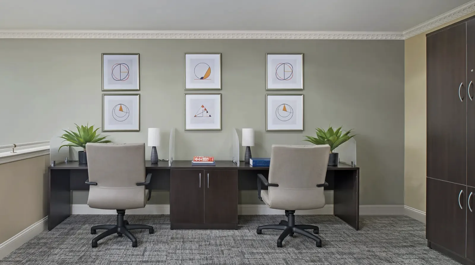 The business center: two workstations with desk lamps and privacy screens at Comfort Cove Senior Living in West Bloomfield, MI